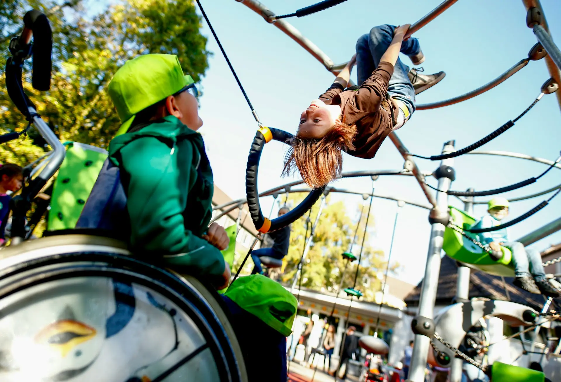 man in green jacket and brown pants riding on white and black swing during daytime